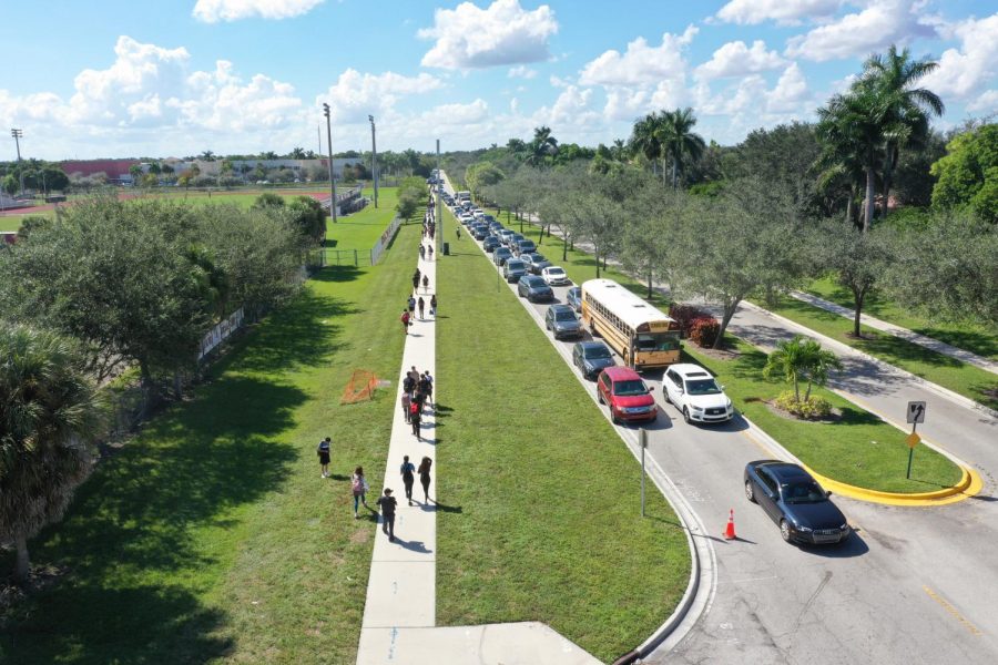 Hold On, Holmberg. Buses, students, parents and regular cars pile up easily each day at 2:40 p.m. on Holmberg Road as school lets out at Marjory Stoneman Douglas High School. The traffic tends to reach the Westglades Middle School car line on a daily basis. 