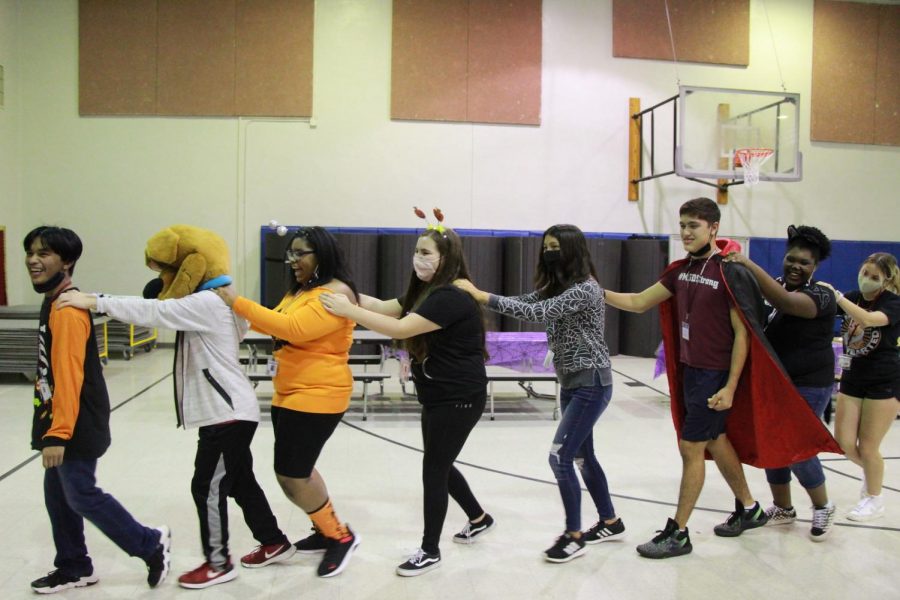 Best buddies members dance along to music dressed in their halloween costume.