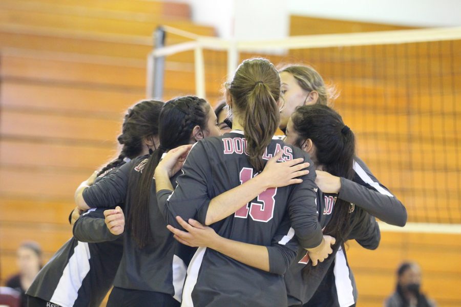 Team work makes the dream work. MSD womens JV volleyball players celebrate after earning a point.