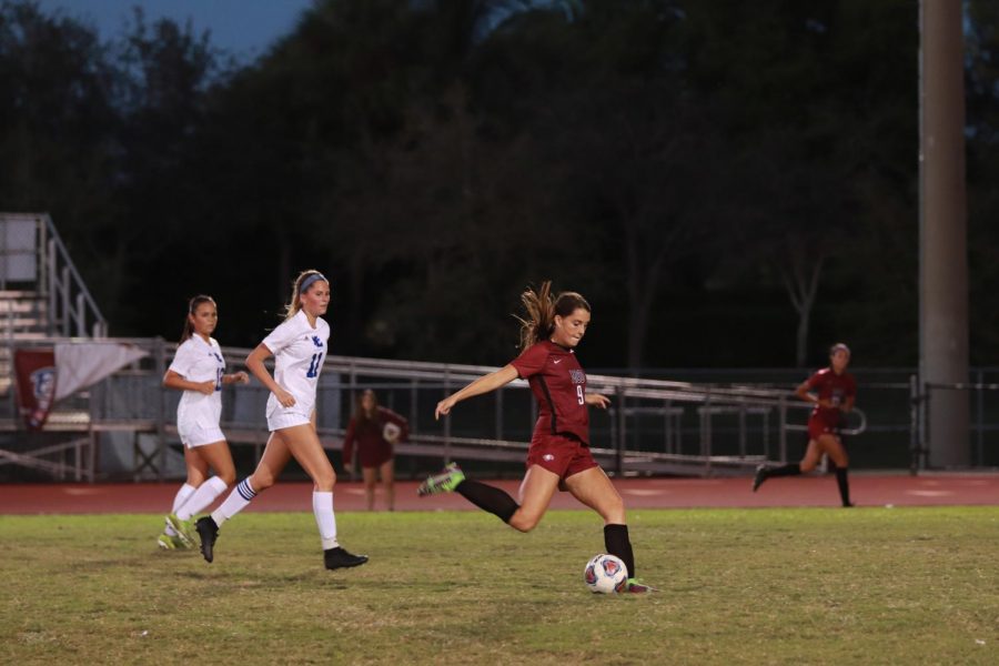 Hat Trick. Forward Gianna Rizzo (9) attempts to score during the womens varsity soccer match against Fort Lauderdale High School. Rizzo went on to score three goals in the games duration.