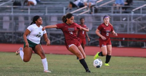 Forward Kyra Tuesta (14) prepares to kick the soccer ball downfield after intercepting it from the opposing Nova offense. The Eagles went on to win the game 12-0 on their senior night.