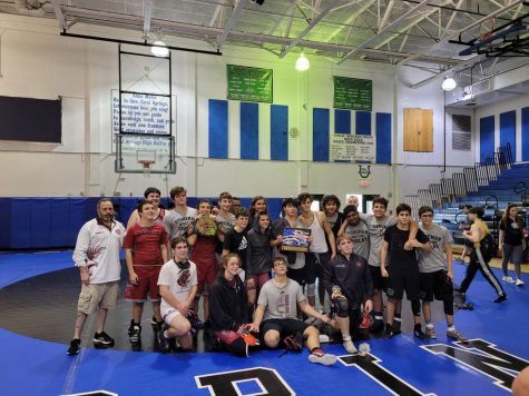 MSDs wrestling team poses together for a photo with the Coral Springs Duals Tournament plaque after winning the event. They had a 42-36 victory against Western High School in the final match. Photo courtesy of the MSD wrestling team