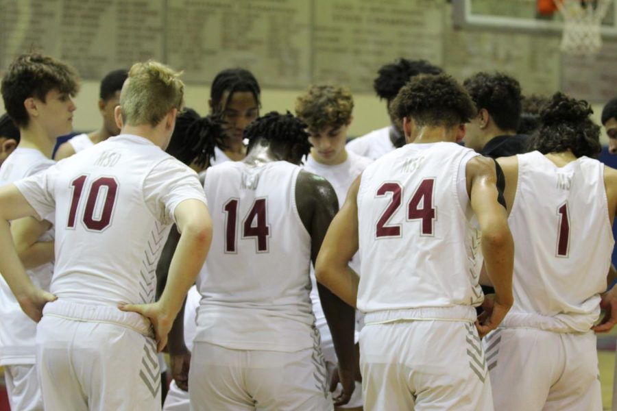 The+mens+varsity+basketball+team+huddles+during+a+timeout+in+their+home+match+against+J.P.+Taravella+High+School.+The+Eagles+went+on+to+win+the+game+58-55+as+their+second+win+of+their+win+streak.