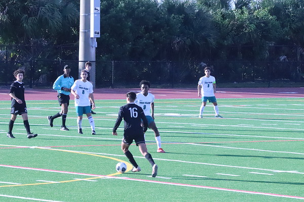 Midfielder Tomer Yair (16) takes the ball upfield against the opposing Coral Glades defense. The Eagles went on to lose in a penalty kickoff by a score of 4-3.