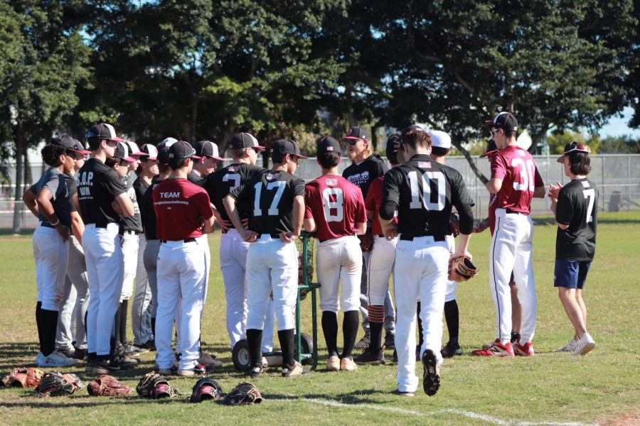 JV baseball coach Max Boling and the players gathered together on the first practice of the season.