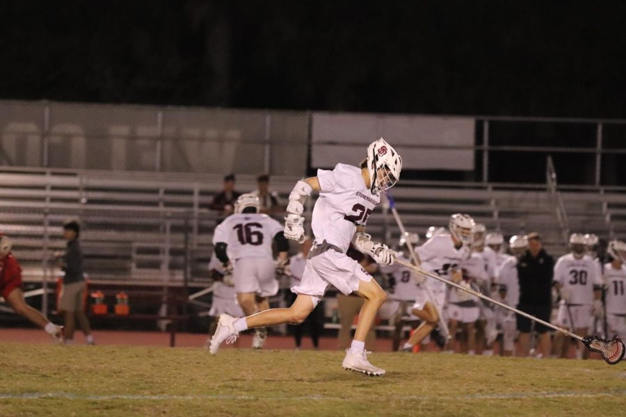 Midfielder Matthew Nason follows through with a play in the first lacrosse game of the season against Kings Academy on Feb. 15.