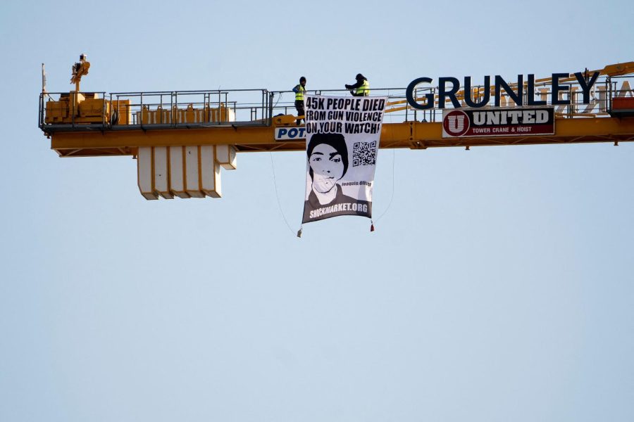 Manuel Oliver displays a banner calling on government officials to prioritize gun violence prevention from a construction crane near the White House in Washington, D.C., on Monday, Feb. 14, 2022. Oliver's son Joaquin Oliver was killed in the Parkland School shooting four years ago today. 