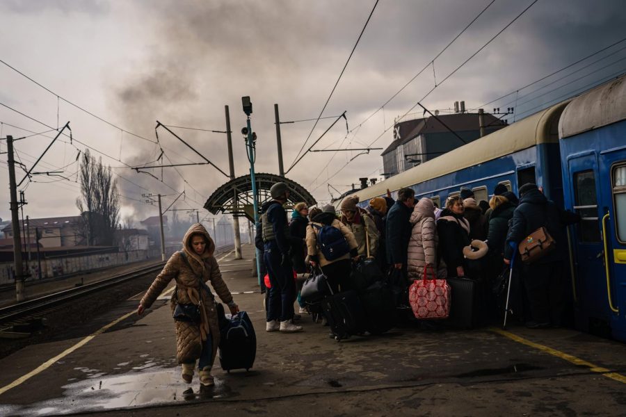 Civilians, mostly women and children, rush to board any train car that still has any room on it, as the sounds of battle D gunfire and bombing D fighting between Russian and Ukrainian forces draw closer to the city of Irpin, Ukraine, Friday, March 4, 2022. Photo courtesy of Marcus Yam/Los Angeles Times/TNS
