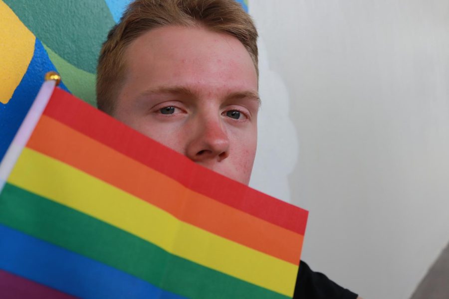 Students feel silenced now that they are no longer allowed to say gay in schools under Florida law. Freshman Riley McCleary covers their mouth with a pride flag signifying they will not stay silent about their sexuality.