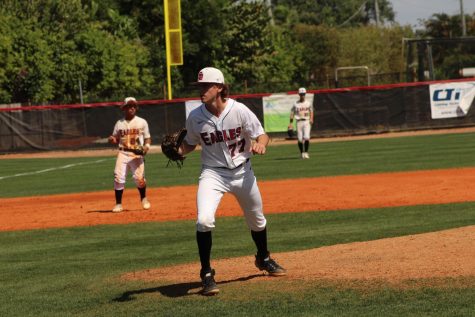 Pitcher Gabriel Jardine (77) finishes his pitching motion in the teams March 19 match against Cardinal Gibbons. The team went on to win the game 3-1 after the Eagles pitching staff through a combined 14 strikeouts.