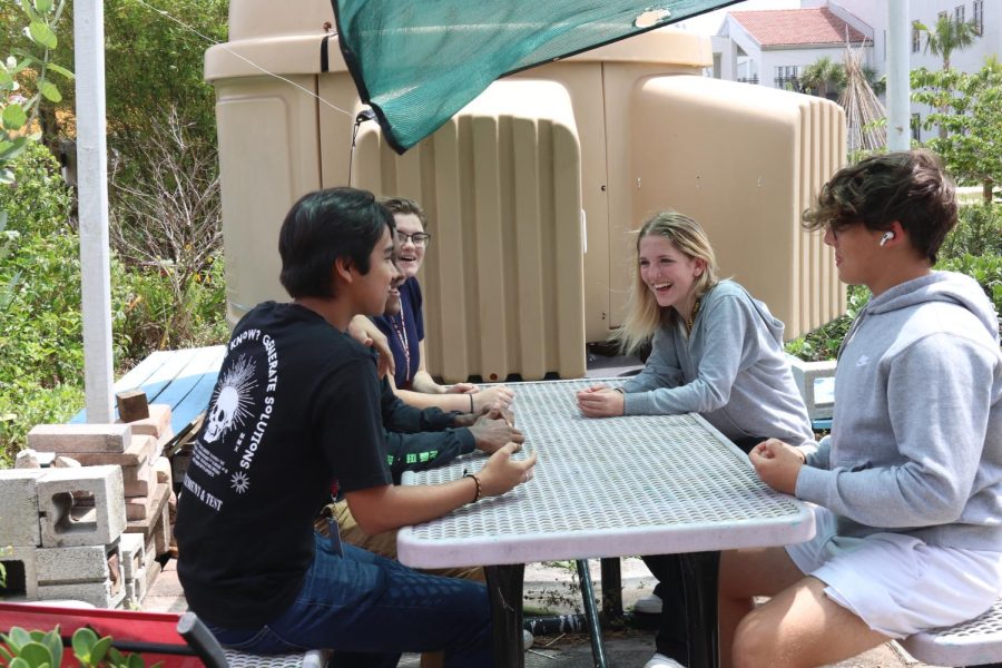 Greetings Garden. MSD students enjoy eating lunch together at a table in the Stomen Douglas Garden.
