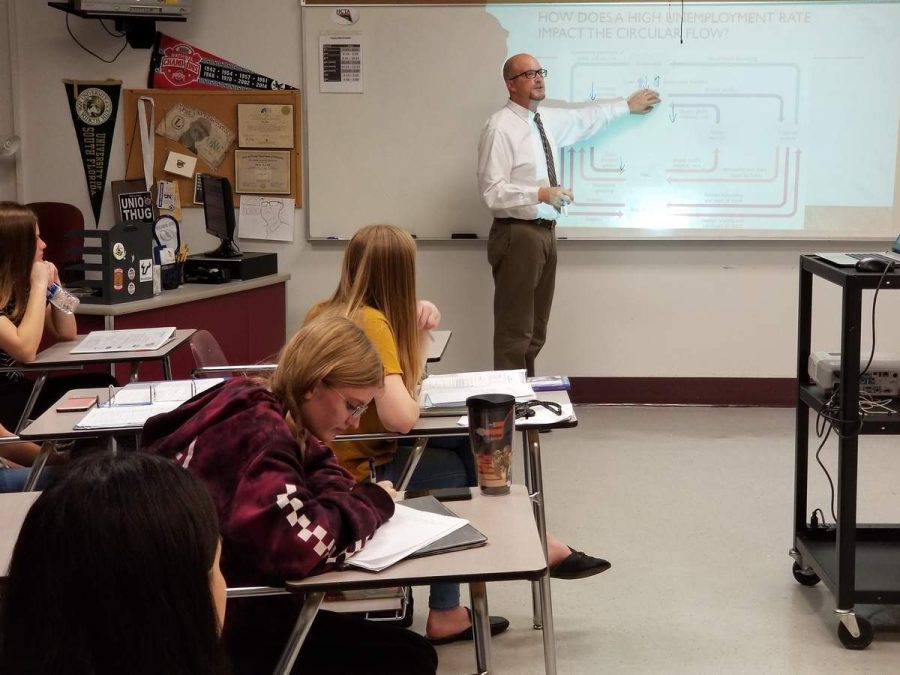 Brandon High School economics teacher Brian Ayres gives a lesson. He said this year that his Advanced Placement macroeconomics students dont get time to learn financial literacy, because its not part of the curriculum. But a new law signed by Gov. Ron DeSantis Monday will ensure every student is taught the topic. Courtesy of Jeffrey S. Solochek/Tampa Bay Times/TNS.