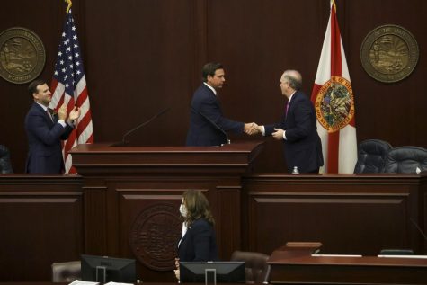 Gov. Ron DeSantis shakes hands with Senate President Wilton Simpson, R-Trilby, at the Capitol in Tallahassee during Opening Day of the Florida Legislature on March 2, 2021. DeSantis has endorsed Simpson in the Republican primary for agriculture commissioner, ending speculation. Courtesy of Ivy Ceballo/TNS.