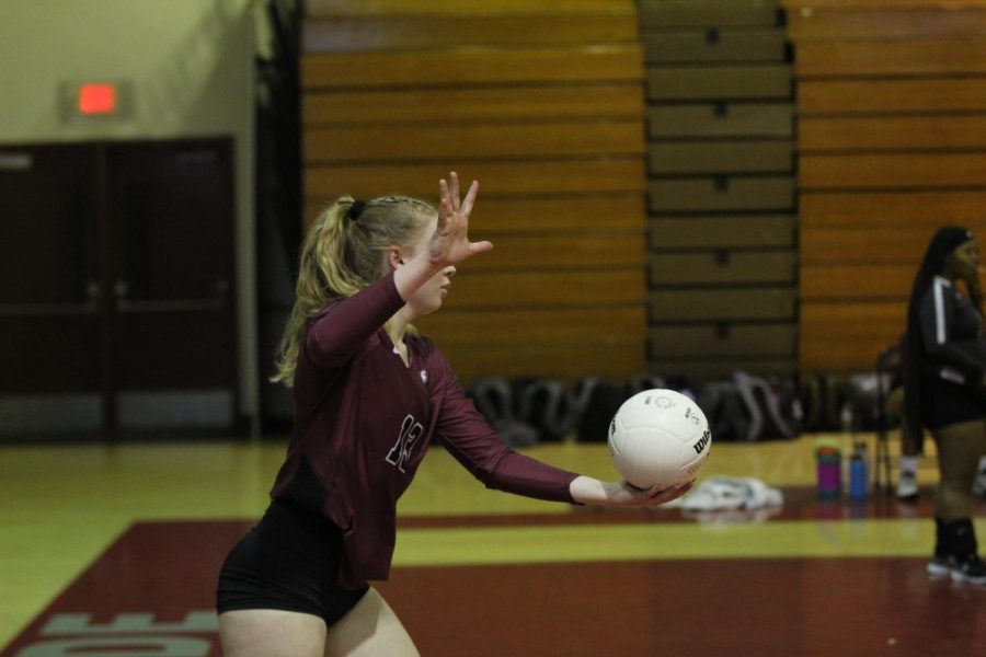 Cameron Ulinski (13), one of the star players in Wednesdays match, as she prepares to serve for her team. She would go on to contribute to the team both offensively and defensively.