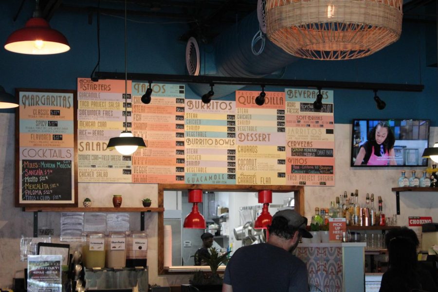 Mighty+menu.+The+Taco+Project%E2%80%99s+menu+has+many+different+food+options+displayed+on+their+colorful+menu.+They+offer+a+variety+of+Mexican+dishes+ranging+from+crunchy+burrito+bowls+to+sweet%2C+doughy+churros.
