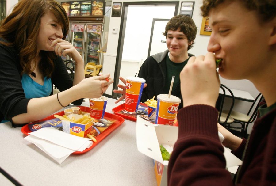 Borah High School students, from left, Katy Sword, 17, Lane Wade, 15, and Tucker Nelson, 18, have a bite to eat after band practice, February 3, 2009 in Boise, Idaho. Sword works two part-time jobs to afford food, gas, clothes and the expenses that come with being in the high school band. (Kerry Maloney/Idaho Statesman/MCT)
