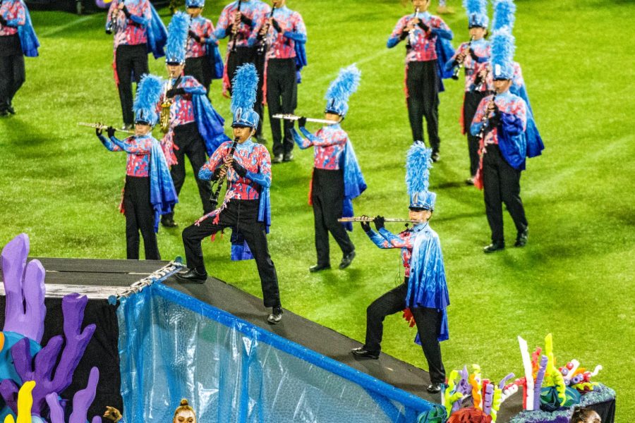 Junior Dylan Lynton performs his clarinet solo midway through the The Living Seas marching band show. He had to audition for the special part against his section leader and ultimately secured the solo spot after hours of practice. Photo courtesy of Scott Rush
