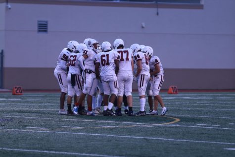 The MSD JV football team groups together for a huddle. The Eagles teamwork led them to win 22-14.