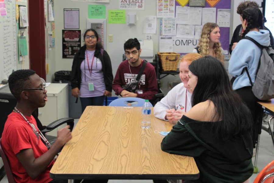 Members of Best Buddies gather around eating with one another to pair up for the year. This was the first lunch party Best Buddies has held this school year; the goal was for everyone to meet one another and pick their buddy pairs for the year.