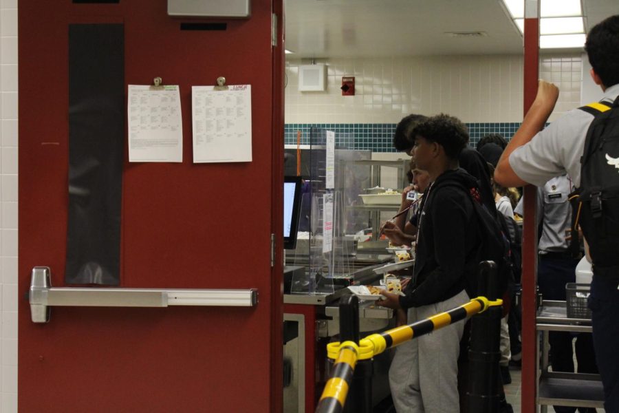 A student is purchasing his lunch at the front of the line. After the pandemic, students in Broward County have to buy lunch for $2.50 unless approved for free or reduced lunch.
