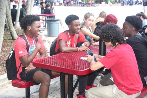 During B lunch, students sit and talk together in the courtyard. They wear red on Friday to show support for Red Ribbon Week.