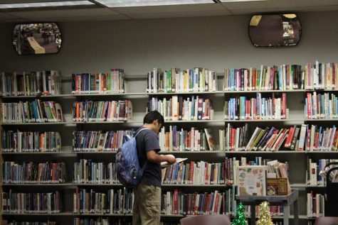 A student in the MSD media center looks through the shelves of books to find one that fits his interests best. Representation for teens can be found in the characters written within numerous novels.