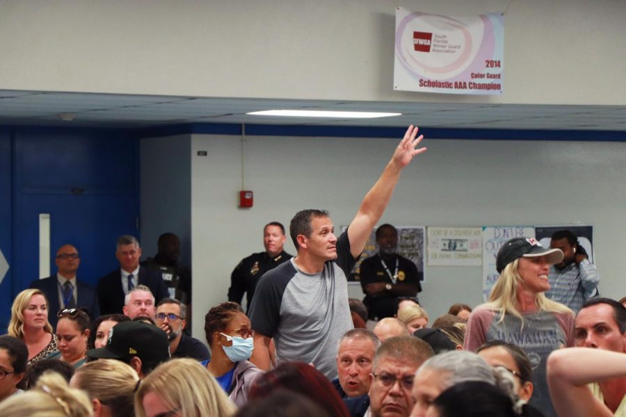 Keep ‘em Coming. A community member urgently raises his hand to ask a question at the Oct. 3 boundary meeting. After the demographer Joseph Beck went through the PowerPoint, the floor was opened up for questions about the process.