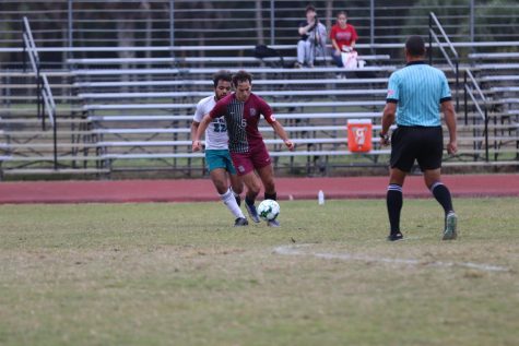 Midfielder Tomer Yair drives the ball across the field. The Eagles scored three goals in the game against the Coral Glades High School Jaguars. Yair made two goals in the game that contributed to the final score of 3-0.