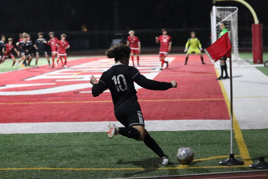 Midfielder+Joaquin+Gonzales+%2810%29+kicks+the+ball+off+the+field+to+his+team+in+the+game+against+Cardinal+Gibbons+High+School.+Gonzales+highly+contributed+to+his+team+score%2C+1-1.