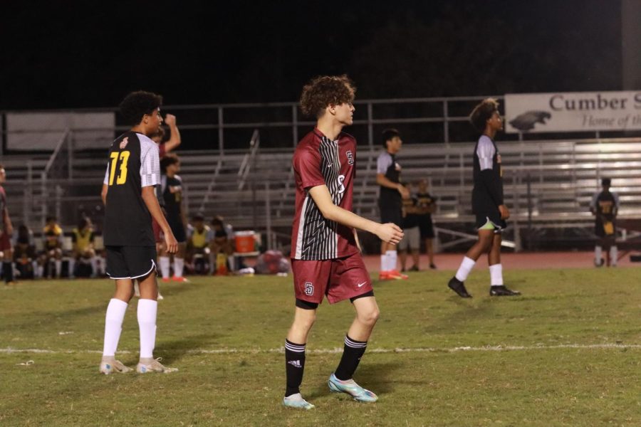Defender Robert Hugus (9) reads a pass and gets ready to receive the ball in the match against South Plantation High School. Hugus is one of the seven seniors on the team.