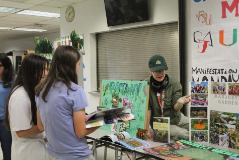 Getting Green. A representative for the Botany Club and Marjorys Garden Club speaks to incoming freshmen about the program. Extracurricular clubs and activities were able to showcase themselves in the Cafeteria during curriculum night.