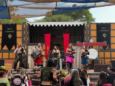 The Reelin Rogues perform on stage in front of a live audience at the Florida Renaissance Festival. Audience members could have tipped the performers and could interact with the background dancer.