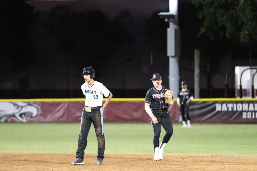 Infielder+Devin+Fitz-Gerald+enters+his+stance+before+a+play+while+watching+the+opposing+runner+of+the+West+Broward+High+School+Bobcats.+The+MSD+varsity+baseball+team+defeated+the+Bobcats+10-0.