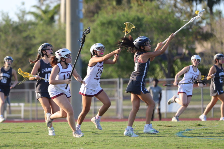MSD+varsity+lacrosse+players+pressure+NSU+University+School+player+in+their+pursuit+to+take+back+the+ball.+They+attempt+to+get+a+turnover+in+order+to+score+once+more.