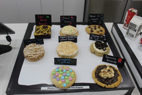 Cookiehead bakery releases four new flavors featuring Springtime M&M, Scorchs Smores, vegan/gluten-free Coconut Cream, and Cinnamon Toast Crunch Treat. The cookies each have a main character associated with them.