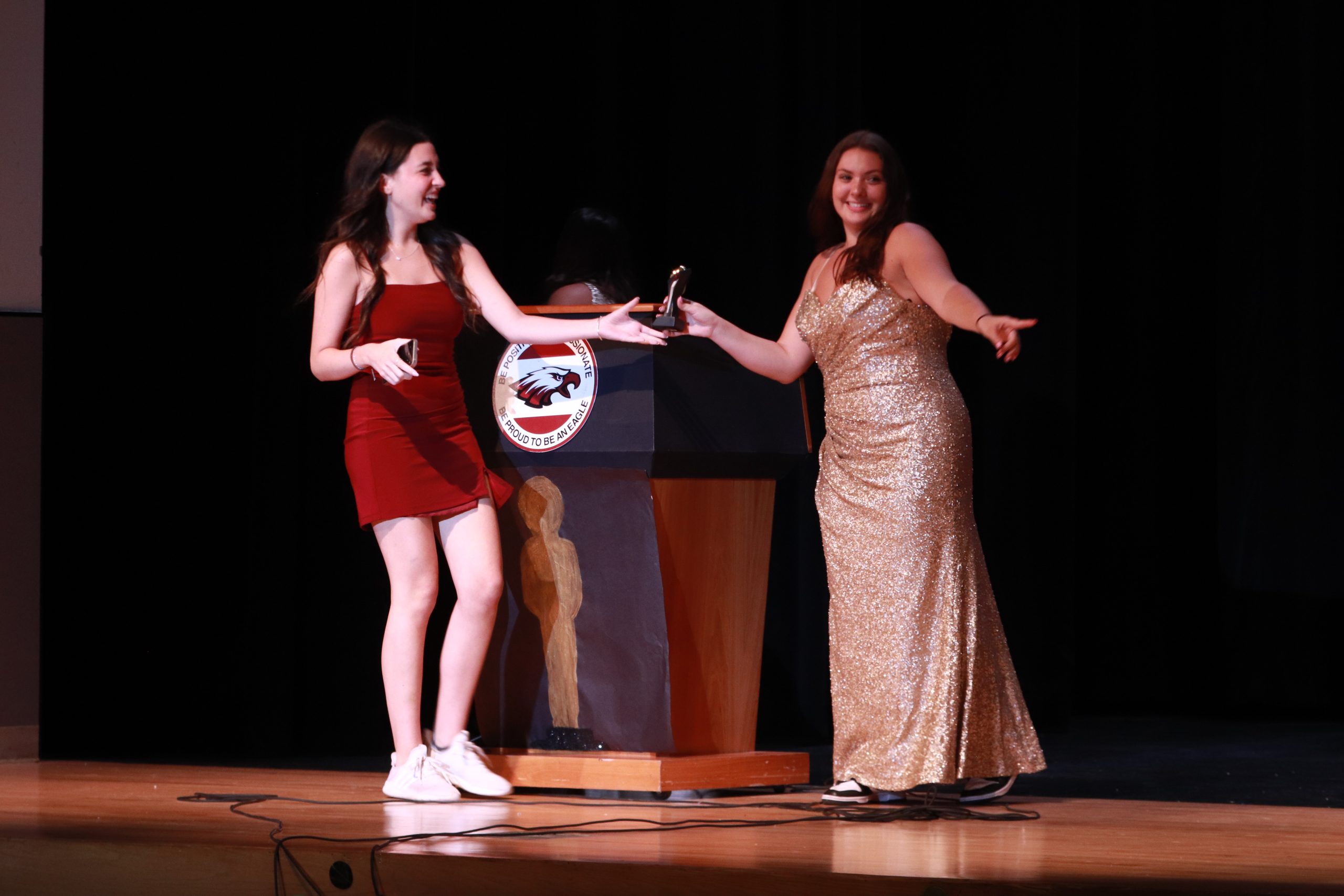 Senior Adriana Pena receives her trophy for the award, Broadway Bound, from Senior Faith Weiss. Weiss acted as the traditional trophy distributor as seen on the Oscars.