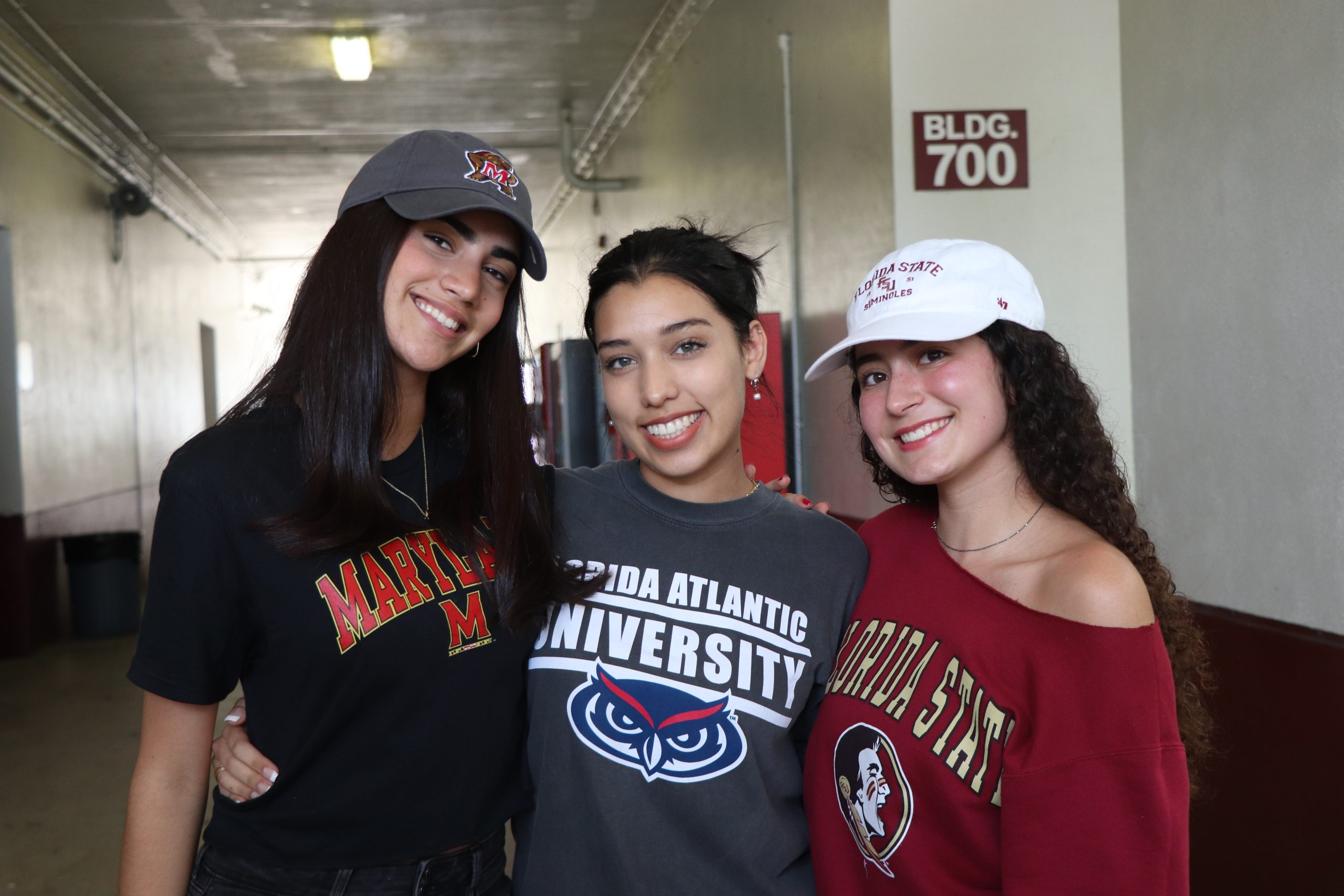 Senior Class Senator Alya Abufele, Senior Class President Renata Garcia and Senior Class Vice President Gabriella Fayad show off their college commitments. April 27, was the unofficial college commitment day at Marjory Stoneman Douglas High School, where the Seniors wore their college attire.