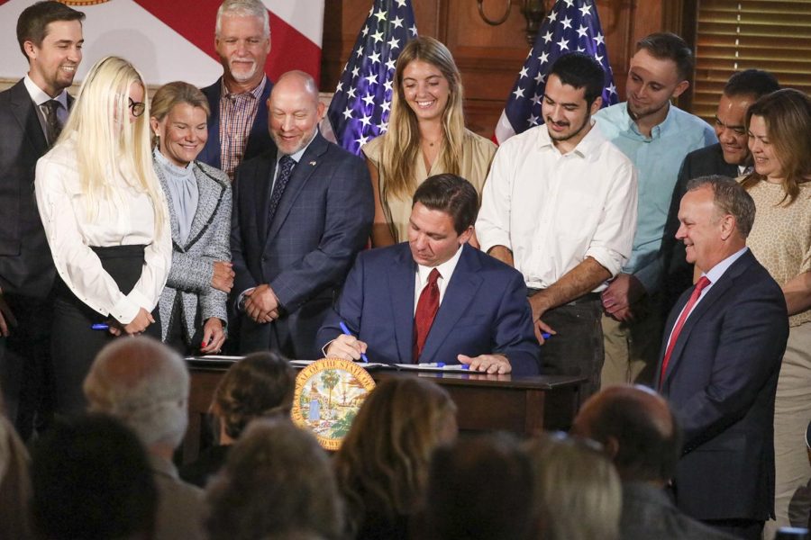 Florida Gov. Ron DeSantis signs legislation on Monday, May 15, 2023, banning state funding for diversity, equity, and inclusion programs at Floridas public universities, at New College of Florida in Sarasota. Photo permission from Douglas R. Clifford/Tampa Bay Times/TNS.
