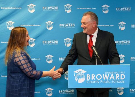 Broward School Board chair, Lori Alhadeff, District 4, left, shakes the hands of Peter Licata, right, after the board voted 7-2 to name him its new superintendent, Thursday, June 15, 2023, inside the School Board room at Kathleen C. Wright Building in Fort Lauderdale, Florida. Photo permission from Carl Juste/TNS.