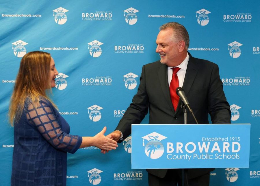 Broward School Board chair, Lori Alhadeff, District 4, left, shakes the hands of Peter Licata, right, after the board voted 7-2 to name him its new superintendent, Thursday, June 15, 2023, inside the School Board room at Kathleen C. Wright Building in Fort Lauderdale, Florida. Photo permission from Carl Juste/TNS.