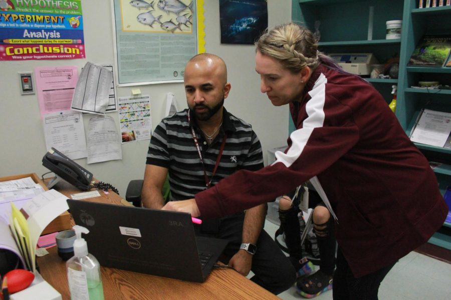 English teacher Holly Van Tassel explains to science teacher Terrence Narinesingh how to sign up for eDues. Due to new laws restricting public union dues from being collected from employee paychecks, all MSD teachers that are members of the Broward Teachers Union had to set up automatic payments from their bank accounts to pay their future dues.