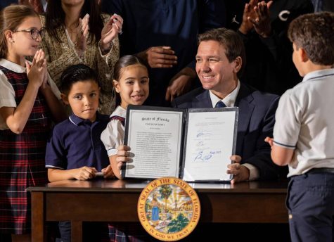 Florida Governor Ron DeSantis reacts after signing a bill to expand private school vouchers across Florida during a press conference at Christopher Columbus High School on Monday, March 27, 2023, in Miami, Fla. Photo permission from Matias J. Ocner/TNS.