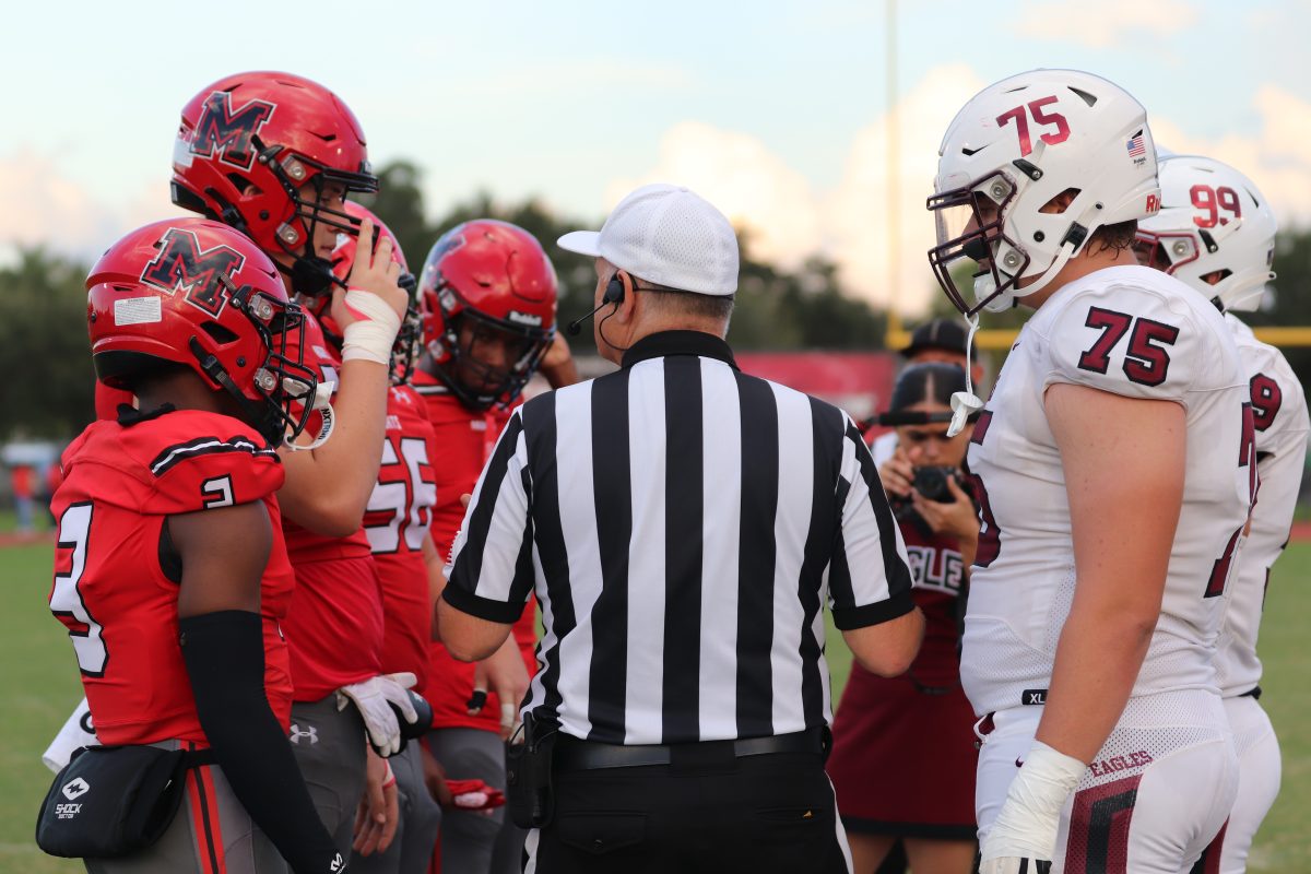 Marjory+Stoneman+Douglas+High+School+football+captains+Jeremy+Fishkin%2C+Jack+Grubor+and+Ryan+Cruz+face+the+Monarch+High+School+captains+in+the+annual+Homecoming+game+for+the+coin+toss.+The+Eagles+began+the+kickoff+for+the+Eagles+homecoming+game.