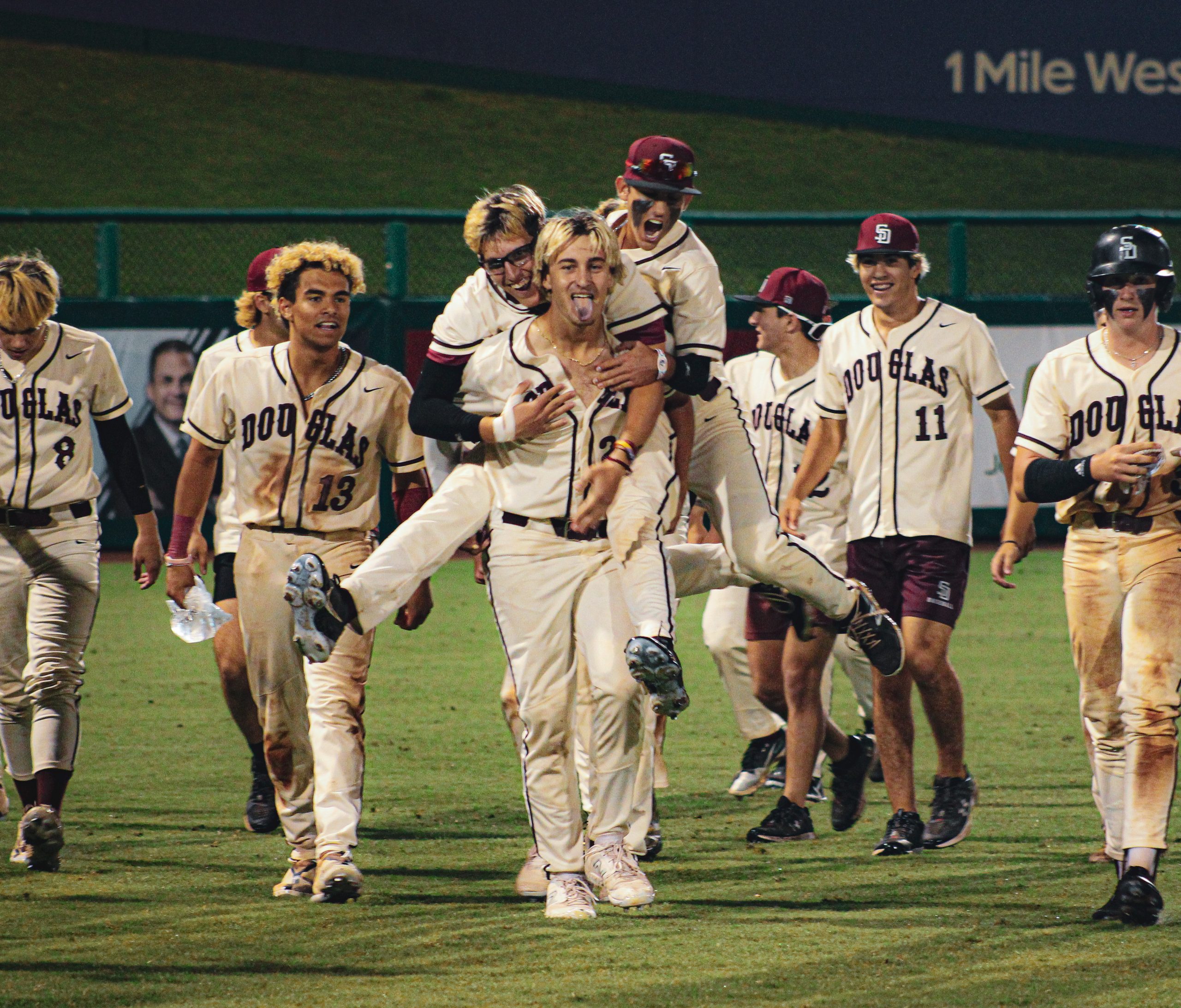Jumping on outfielder Reese Burton (21), the MSD varsity baseball team celebrates their third state victory in a row. The FHSAA State Championships were held at Fort Meyes Hammond Stadium.
