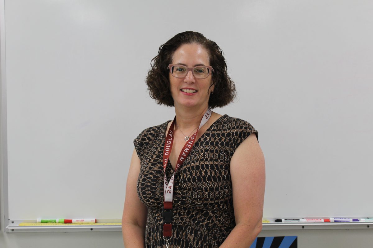 New algebra teacher Rosemary Cernech stands by her white board, ready to teach. Cernech has been teaching math for 12 years between Texas and in Florida and is excited for the new school year.