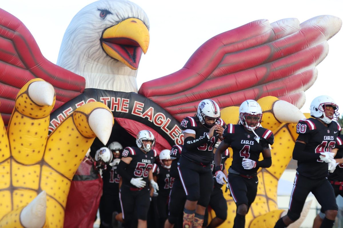 The varsity team runs out of the inflatable eagle at Cumber Stadium. This was the first home game of the season against Jensen Beach.