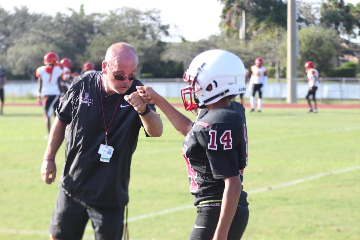 Coach Christian Baldwin shares a moment with Eduardo Llavaneras (14). This was at the first junior varsity game of the season.