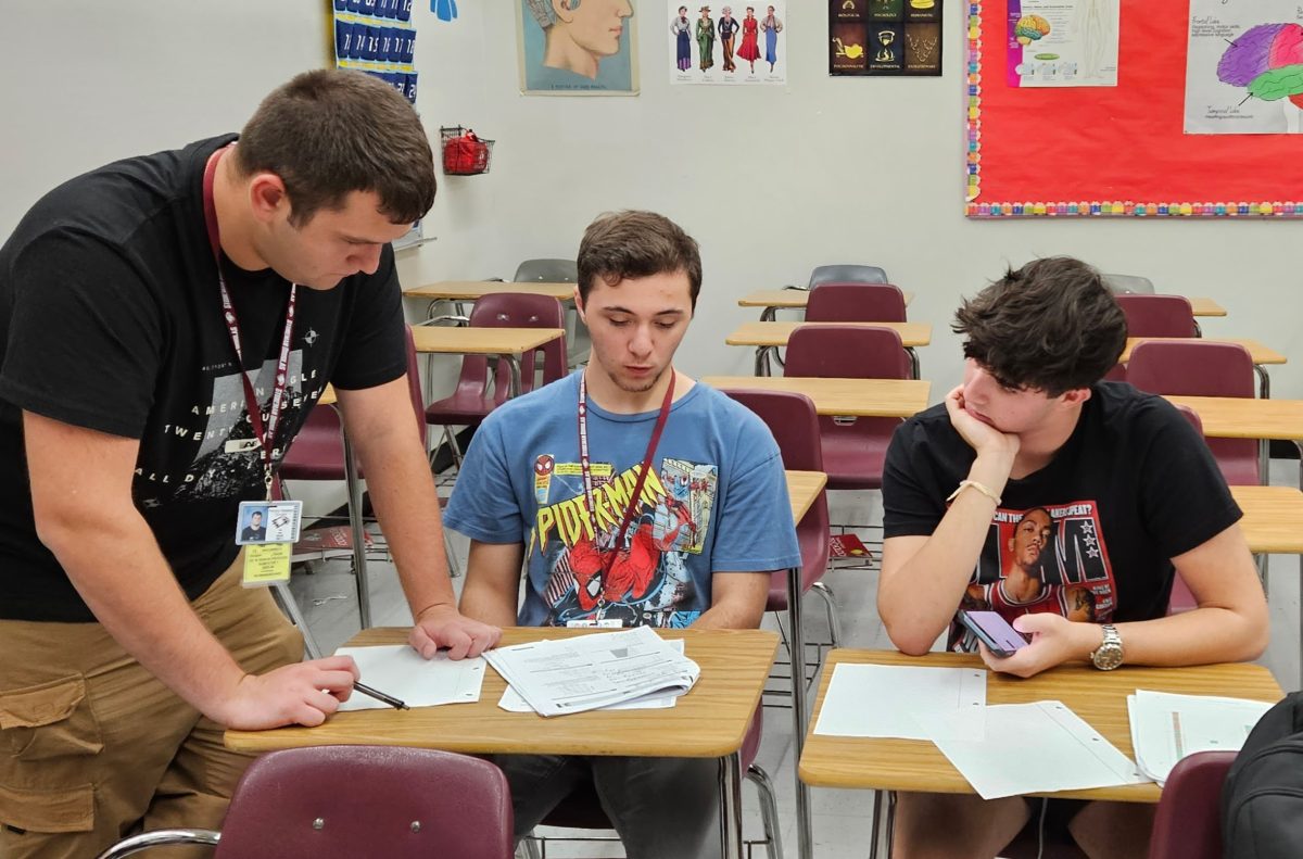 National Honor Society members seniors Jack Lickerman and David Itingen tutor junior Brian Gelske for the math portion of the SAT. The National Honor Society held their first tutoring session of the year after school in room 423 on Tuesday, Sept. 26.