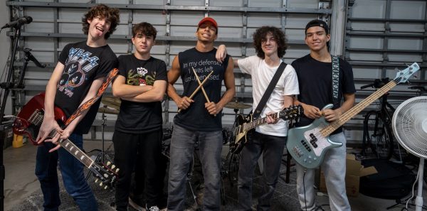 Rock band HB Boulevard stands with their instruments in hand after a practice in their lead singers garage. The band consists of vocalist Lawson Jay, lead guitarist Jose Nunez, rhythm guitarist Logan Siskin, drummer Josiah Jimenez, and bassist Anthony Pelito, who are all seniors at MSD.