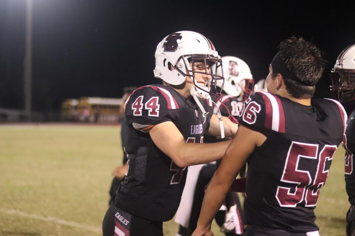 Defensive back Nick Maresca (44) and inside linebacker and long snapper Robert Meis (56) celebrate their team scoring. The Eagles played South Broward High School and scored 21 points.